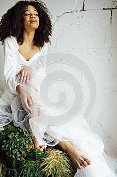 Fashion and beauty shooting a charming mixed race girl in a long dress