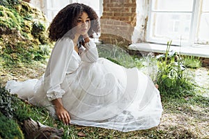 Fashion and beauty shooting a charming mixed race girl in a long dress