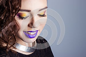 Fashion beauty shot of a beautiful young girls with bright makeup and purple lips in the Studio on white background