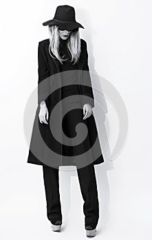 Fashion Black and white photo. Glamorous blonde in classic coat