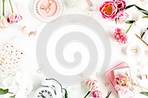 Fashion blog pink style desk with accessories, tulip flowers, scissors, coffee cup on white background. Flat lay. Top