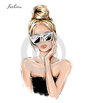 Fashion blond hair girl in sunglasses. Beautiful woman face. Fashion woman with hair bun.