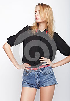 Fashion blond woman model posing in studio