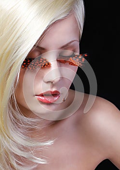 Fashion Blonde Model with Long Orange Eyelashes.