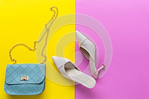 Fashion blue bag and white shoes woman accessories on  pastel color background.