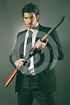 Fashion bodyguard poses with shotgun