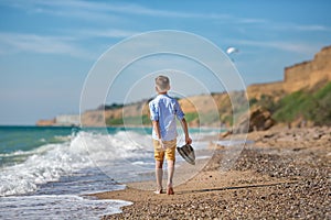 Fashion boy on the beach with hat and sun glasses