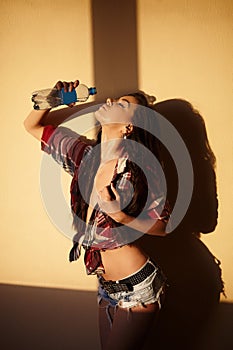 Fashion brunette girl in jeans and shirt