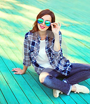 Fashion brunette woman in casual checkered shirt