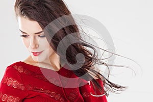 Fashion brunette woman with long hair fluttering in the wind