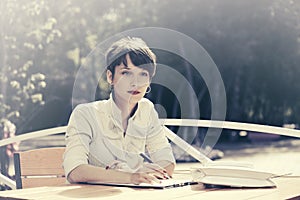 Fashion business woman working at sidewalk cafe