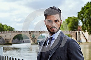 Fashion businessman looking future on river in Rome