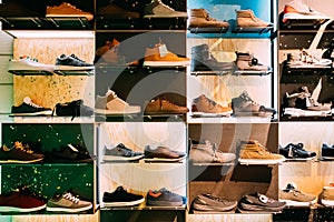 Fashion Casual Male Sneakers On Shelves In Store Of Shopping Cen