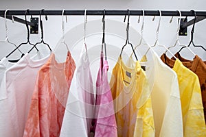 fashion casual t-shirts hanging at store place. colorful choice for buy clothes