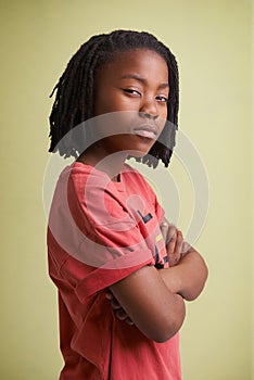 Fashion, children and portrait of black boy in studio with arms crossed in confidence on green background. Mockup, face