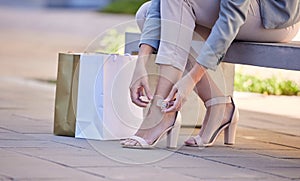 Fashion, city and woman tie heels after shopping in retail boutique store. Shopping bag, discount deals or female in