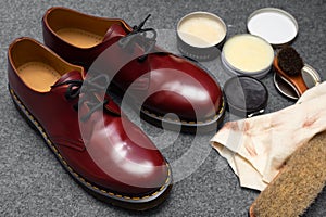 Fashion classical cherry red oxblood men`s leather shoes with black laces and shoe maintenance set.