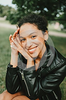 Fashion close up portrait of attractive young natural beauty African American woman with afro hair in black leather