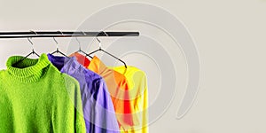 Fashion clothes on clothing rack - bright colorful closet. spring cleaning concept. Copy space