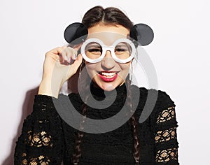 Fashion concept. Beauty surprised fashion model girl wearing big sunglasses. Young girl. Makeup.