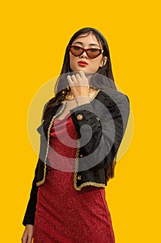 Fashion concept, Fashionable woman wear sunglasses to posing in mini red dress and black jacket