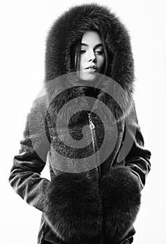 Fashion concept. Girl elegant lady wear fashionable coat jacket with furry hood. Luxurious fur. Girl posing hooded fur