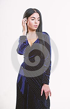 Fashion concept. Woman dress polka dot pattern. Woman elegant lady with makeup long hair wear velvet dark dress with