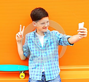 Fashion cool teenager boy is taking picture self portrait