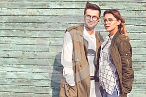 Fashion couple in glasses with glasses in green clothes posing o
