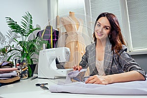 Fashion creative design studio cozy interior with mannequin dummy and tropical palm plant with sewing machine copyspase