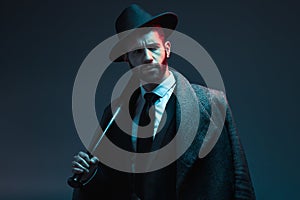 Fashion, criminal and face of man with bat for vintage, retro and Victorian gangster on dark background. Crime aesthetic