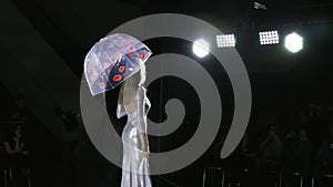 Defile beautiful girl hold umbrella catwalk model show closeup evening vogue 4K. photo