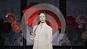 Catwalk charming woman open umbrella defile model show closeup evening vogue 4K. photo