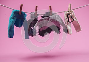 Fashion designer clothes hanging on a rope clipped with pegs