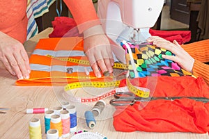 Fashion Designer Cutting Fabric In Studio. Tailor hands working with measure