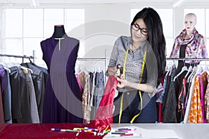 Fashion designer cutting material fabric