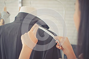 Fashion Designer hand measuring shoulder with measuring tape