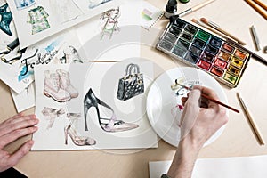 Fashion designer mixes colours of paint