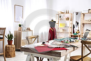 Fashion designer`s workplace in studio. Creating clothes