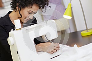 Fashion designer with sewing machine photo