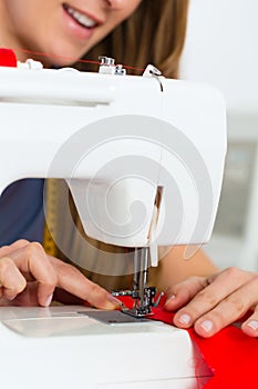 Fashion designer or tailor working in studio