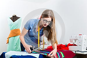 Fashion designer or tailor working in studio