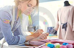 Fashion designer woman working on her designs in the studio.