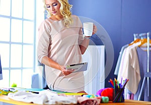 Fashion designer woman working on her designs in the studio.