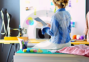 Fashion designer woman working on her designs in the studio