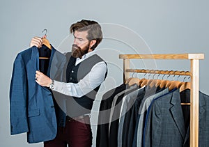 Fashion designer at work. confident tailor designing male jacket. handsome sartor with tape measure. male beauty and photo