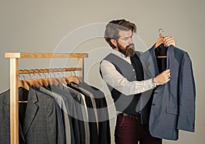 Fashion designer at work. confident tailor designing male jacket. handsome sartor with tape measure. male beauty and