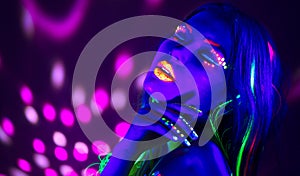 Fashion disco woman. Dancing model in neon light, portrait of beauty girl with fluorescent makeup