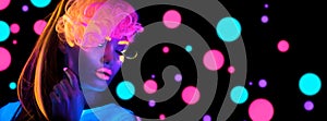 Fashion disco woman. Dancing model in neon light, portrait of beauty girl with fluorescent makeup