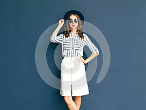 Fashion elegant lady woman wearing a black sunglasses, hat and white skirt